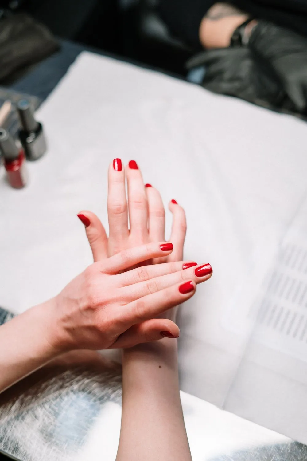 Hands showing a glossy red manicure